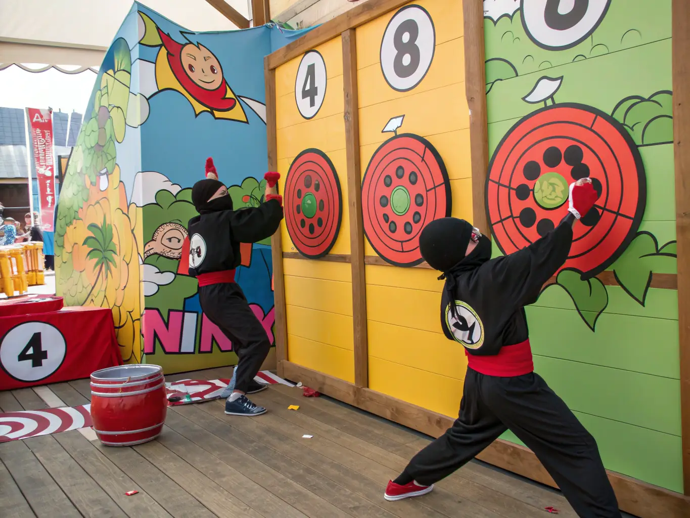 A vibrant, action-packed illustration of cartoon ninjas in dynamic poses, each holding colorful stickers, set against a dojo backdrop, representing the Team Ninja sticker collection for a fun and energetic vibe.